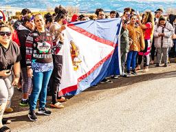American Samoan workers at the turkey plant in Moroni holding America Samoa flag