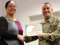 Tira Faiivae receiving her award from Maj. Gen. Steven A. Shapiro