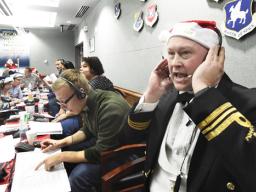 Canadian Lt. Maj. Chris Hache takes a call while volunteering at the NORAD Tracks Santa center 