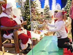 Julianna, 3, and Dylan, 5, visit with Santa through a transparent barrier