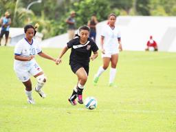 Saono Enesi of American Samoa, right, dribbles away