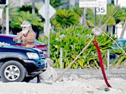 Saute Sapolu carrying a cooking pot