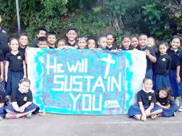 Samoa Baptist Academy 1st graders with their banner