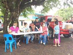 A Crew from the School Lunch Program, sitting at the table yesterday morning at Manulele Tausala Elementary School compound