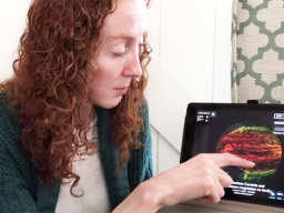 Woman using tablet to access NOAA education website
