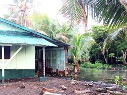 The tide can be seen coming dangerously close to a home in Nuuuli,