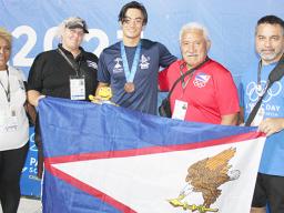Micah with medal and others