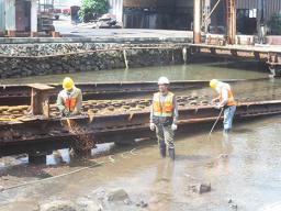 Three Ronald Reagan Shipyard employees, carrying out repair work