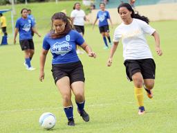 Samoana Sharks’ Deidra Steffany (left) defends against Fa’asao-Marist Cougars’ Lourdes Afoa