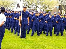 In this photo from the U.S. Coast Guard Family Facebook page. Alaimaleata is leading the whole unit (front) holding the flag.  [courtesy photo]