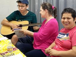 Special needs kids with a parent enjoying making music.
