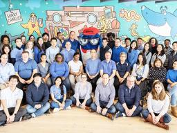 Some of StarKist’s staff in front of the Joe Wos mural