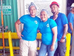 Three StarKist employees dressed in blue pose for the camera.