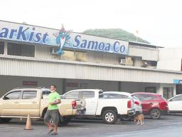 Man walking by StarKist Samoa canning plant