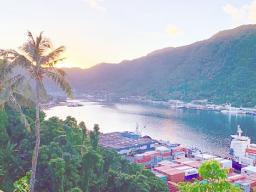 Sun just behind the mountains as it rises over Pago Pago bay