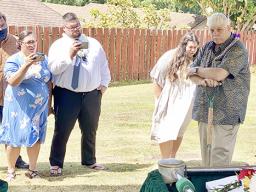 Aaron Tui, his wife Catalina Salafai Markowitz Tui, Abraham Markowitz and Winnie Markowitz watch as their father, Barry Markowitz, shovel in hand, prepares to bury his wife, their mother.