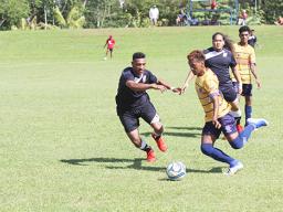 Takai Pouli of American Samoa defends against a Tuvalu opponent