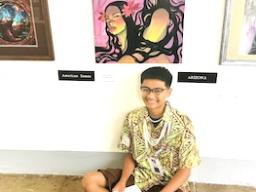 Talanoa Lagafuaina poses next to his most recent art