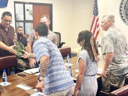 Talauega shakes hands with Army Corps officials