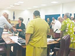 Territorial Administration on Aging Director Evelyn Lili’o Satele shaking hands with lawmakers