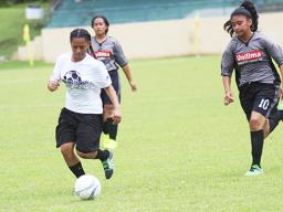 An Ilaoa & To’omata player dribbles away from a Taputimu Youth defender 