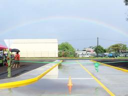 Rainbow over the Tasi Street Extension dedication ribbon
