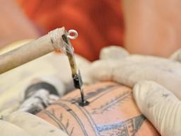 tattoo implement being used