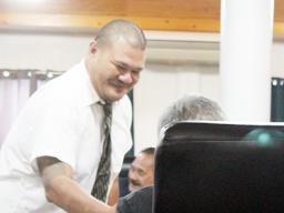 ASG Tax Office Manager Vaaimamao E. Poufa shaking hands with a Senator