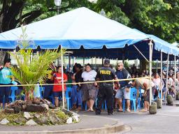 Large crowd under tents in the parking lot of the Territorial Bank of American Samoa