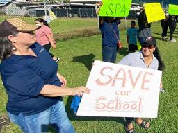 Teachers and demonstrators last week hold signs at SPA