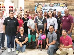 Teni Ma'ae (center) with ACE empolyees wishing him well
