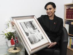 Tonga High Commissioner to the UK, Titilupe Fanetupouvava'u Tu'ivakano with photo of her great grandmother, Queen Salote