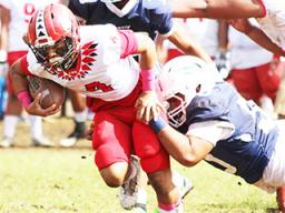 A Samoana defender brings down the Vikings ball carrier