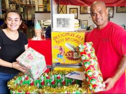 Tiara Drabble (left) received two gifts from a Cost-U-Less employee for the Le Taupou Manaia Dance Academy “Toys & Joy Drive for Samoa” this past Dec. 2019