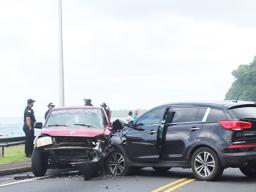 two cars at side of road with damage