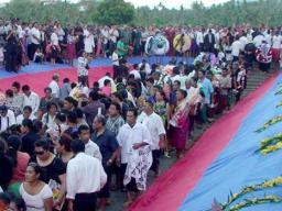 Family members laying flowers and wreaths to farewell the victims at the Tafaigata Cemetery before the mas graves were covered with cement.