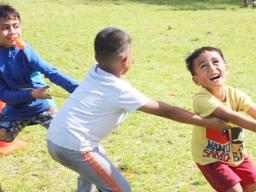 Three youngsters really enjoying themselves during the tug-of-war 