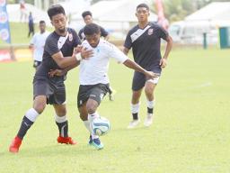 Ueli Tualaulelei (left) of American Samoa defends