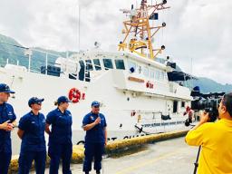 Members of the Coast Guard Cutter Joseph Gerczak and a Coast Guard recruiter give interviews to television reporters in the Port of Pago Pago