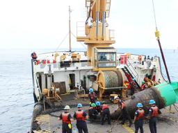 Juniper's crew servicing the green bouy at the entrance to Pago Pago harbor.