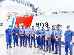 U.S. Coast Guard and Fiji Navy personnel stand in front of USCG cutter
