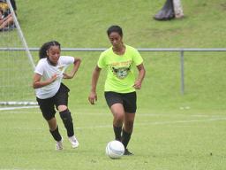 A Pago Youth defender, right, dribbles the ball out of danger against Utulei Youth