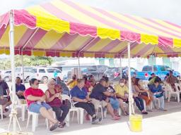 Individuals waiting to get their COVID-19 vaccine under a tent next to the DoH quarantine facility in Tafuna