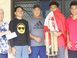 Members of the Vaiala Tongan Boys 13-15 team receive their championship trophy