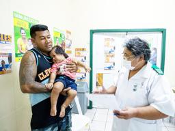 MAN WITH CHILD GETTING A VACCINATION