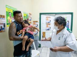 Dad with child getting vaccine