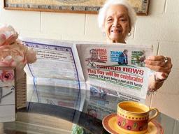Vera Annesley reading the paper