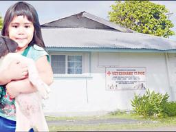child with dog at vet clinic