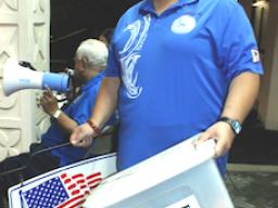 Woman carrying voting boxes
