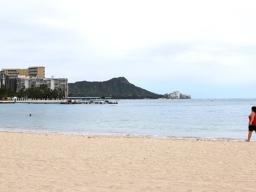 Lone woman walks on Waikiki beach